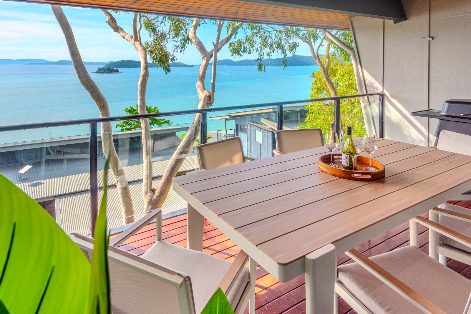 Outdoor balcony dining area overlooking Dent Passage on Hamilton Island.